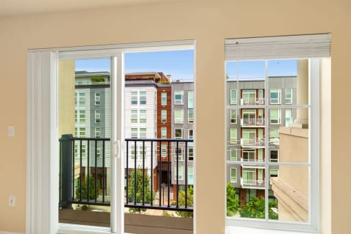 a room with a balcony and a view of a building