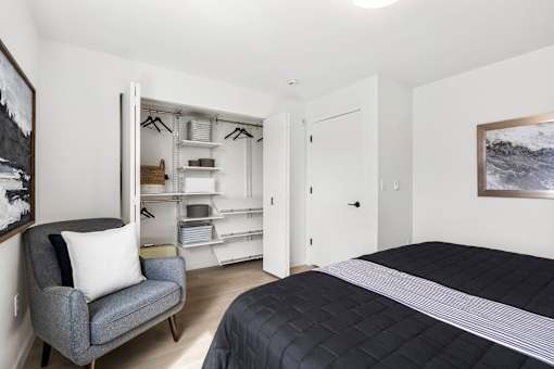a bedroom with a bed and a chair