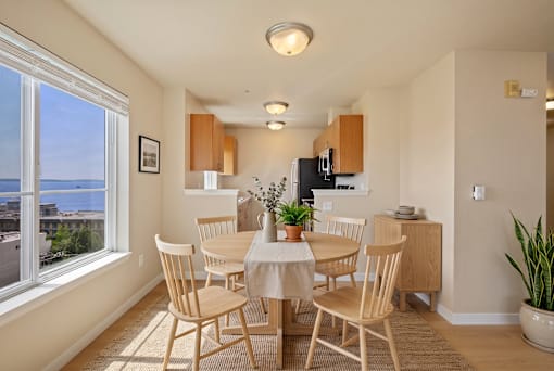 A dining room with a table set for four.