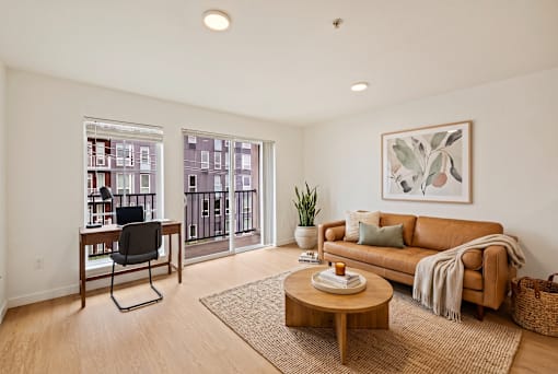 A living room with a brown couch, a coffee table, and a chair.