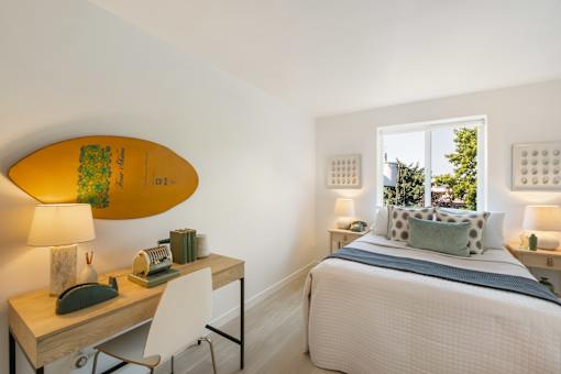 a bedroom with a surfboard on the wall