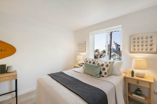 a bedroom with a bed and two night stands with lamps