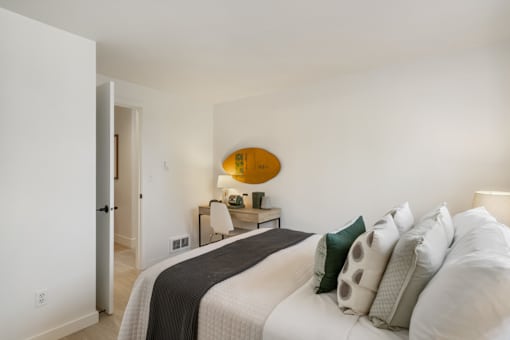 a bedroom with a bed and desk in a 555 waverly unit