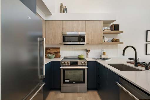 a kitchen with wood cabinets and stainless steel appliances