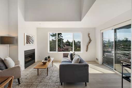 a living room with a couch and a coffee table in front of a fireplace