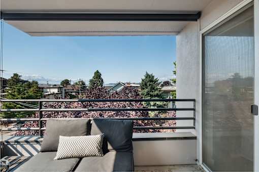 a balcony with a couch and a sliding glass door