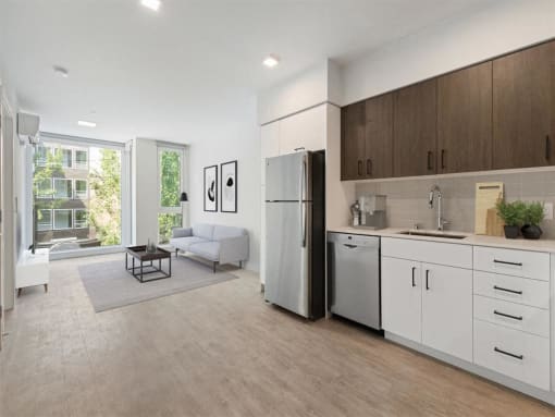 a kitchen and living room with a refrigerator