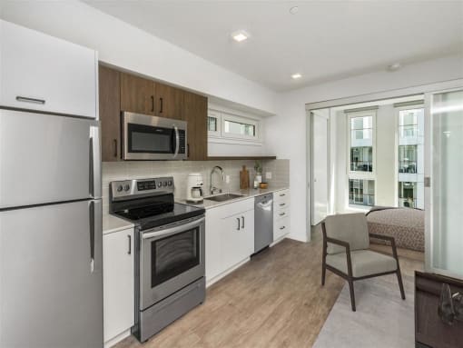 a kitchen with stainless steel appliances and a window