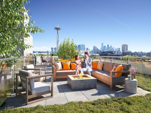 a man and woman sitting on a couch on a rooftop patio