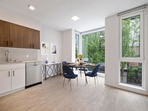 a kitchen and dining room with a large window and a table