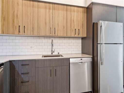 a small kitchen with a refrigerator and a sink