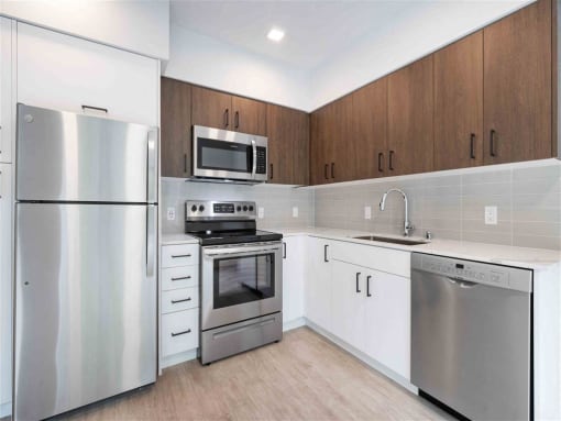 a kitchen with stainless steel appliances and white cabinets