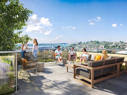 a group of people sitting on a roof terrace with a view of the city