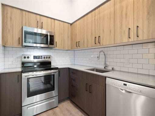 a kitchen with stainless steel appliances and wooden cabinets