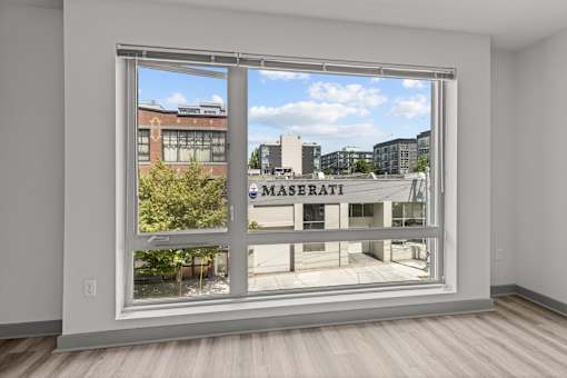 A room with a large window overlooking a city street.