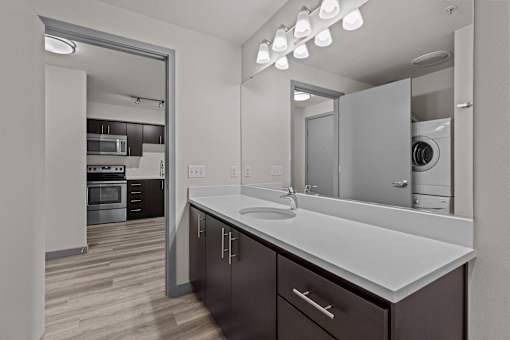 A modern kitchen with dark wood cabinets and white countertops.