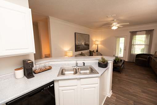 A kitchen with white cabinets and a black dishwasher. at Lakeside Villas, Hampton, 30228