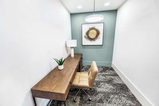 A room with a wooden table and a chair.
