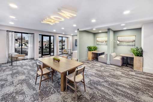 A conference room with a long table and chairs.