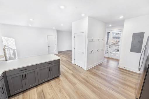 A kitchen with wooden floors and white walls.