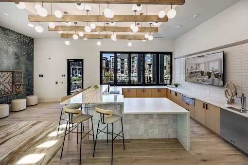 A modern kitchen with a large island and bar stools.