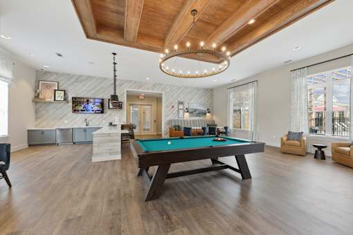 A room with a pool table and a television.