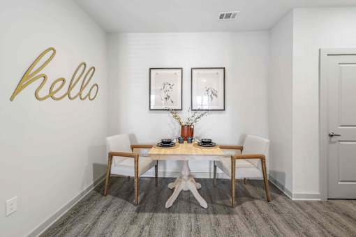 A dining room with a wooden table and chairs.