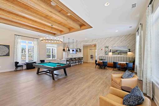 A large room with a pool table and a billiard table.
