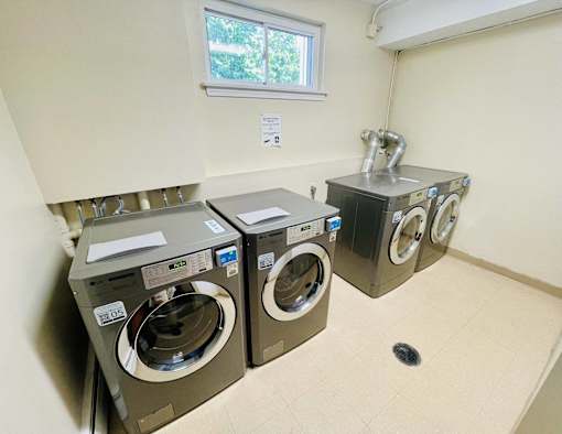 a washer and dryer in a laundry room with a window at Eagle Pointe New London, CT
