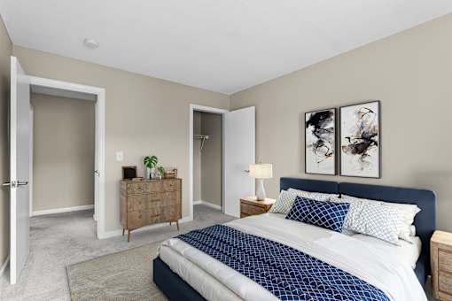 A bedroom with a large bed and a wooden dresser at Rose Hill Estates, Norwich, CT, 06360