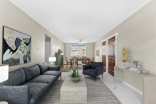 A living room with a grey sofa and a painting on the wall at Rose Hill Estates, Norwich, CT, 06360