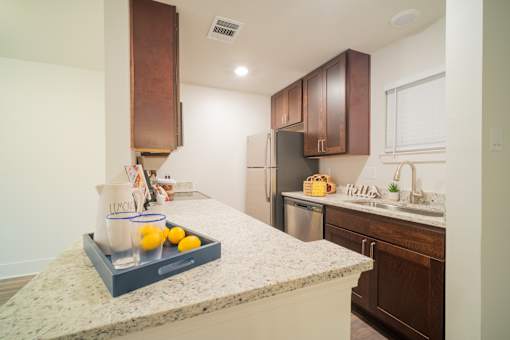 a kitchen with a large island with a tray of lemons on it