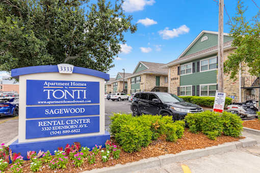 A blue and white sign for Tonti Apartment Homes in Sagewood Rental Center.