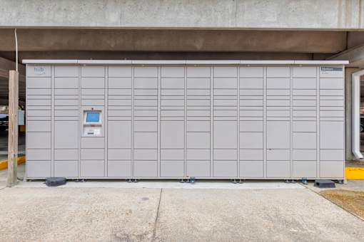 A large grey storage unit with a blue sign on it.