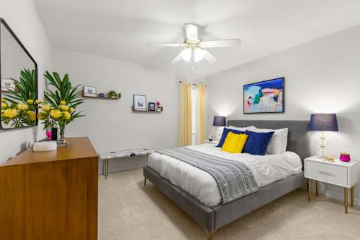 A bedroom with a bed, nightstand, and a painting on the wall.