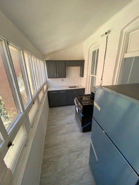 a kitchen with a refrigerator and a stove in it