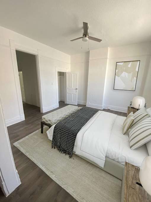 a bedroom with a bed and a ceiling fan