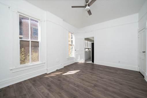A room with wooden floors and white walls.