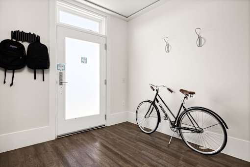 A bicycle is leaning against a wall in a room.