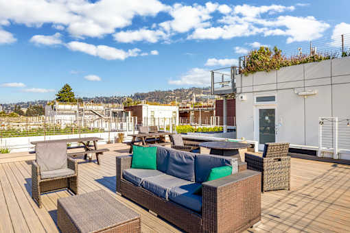 A patio with a couch, chairs, and a table.