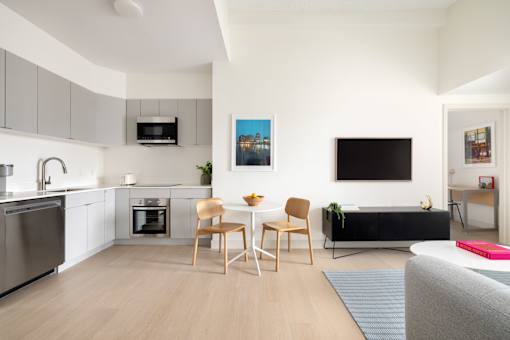 A modern kitchen with a dining table and chairs.