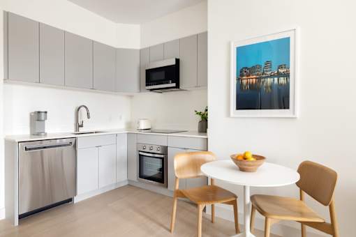 A modern kitchen with a dining table and chairs.