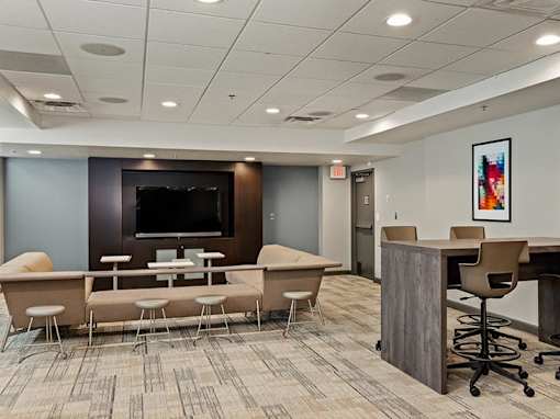 A conference room with a long table and chairs.