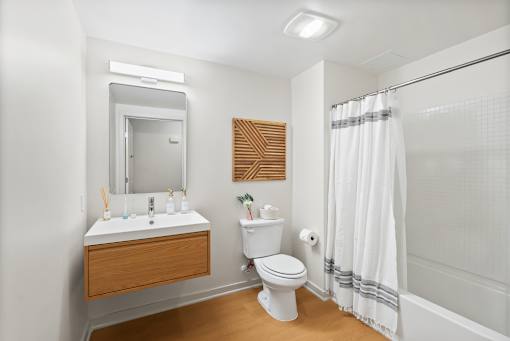 A white toilet sits next to a sink in a bathroom.