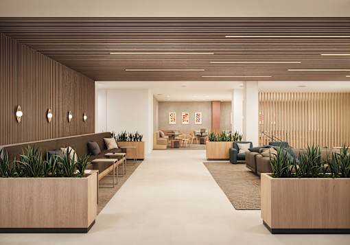 A modern waiting room with wooden furniture and plants.