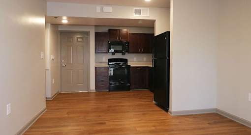 a room with a hallway with a door and a tv