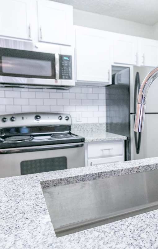 A kitchen with a stove top oven and a microwave.