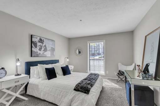 A bedroom with a white bed and a blue headboard.