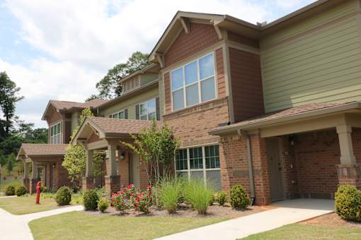 decatur affordable family apartment  a brick house with a sidewalk in front of it