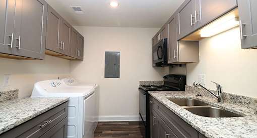 affordable section 8 stone mountain a kitchen with granite counter tops and a sink